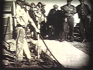 black and white image of men standing on a dock